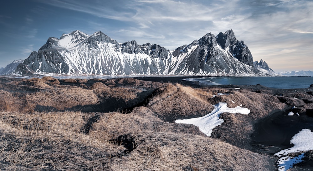 brown and white mountains under white clouds during daytime