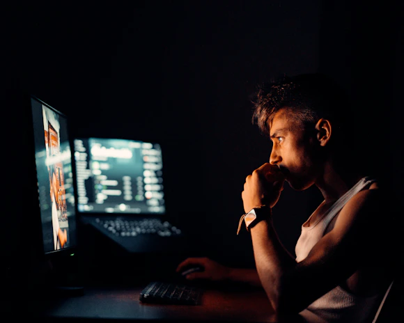 A night shift operator focused on the screen, showing 24-hour dedication.