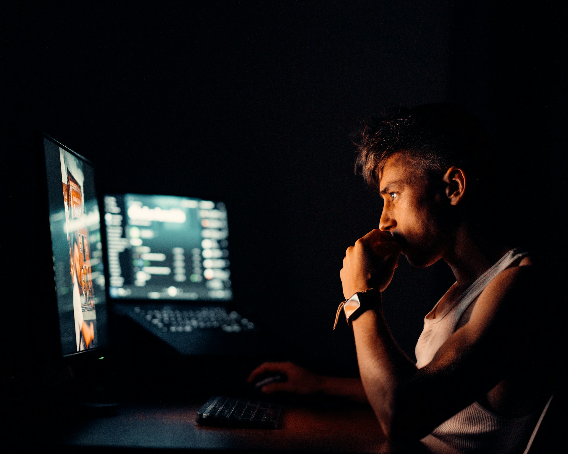 woman in black tank top sitting in front of computer