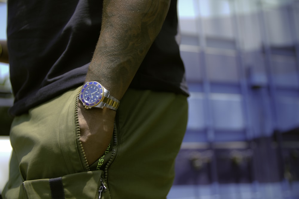 person wearing gold analog watch