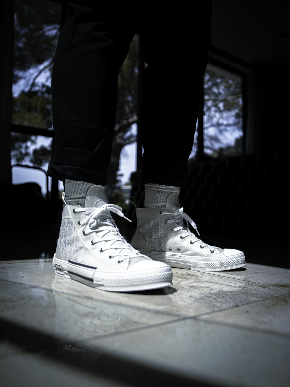 person in blue denim jeans and white nike sneakers