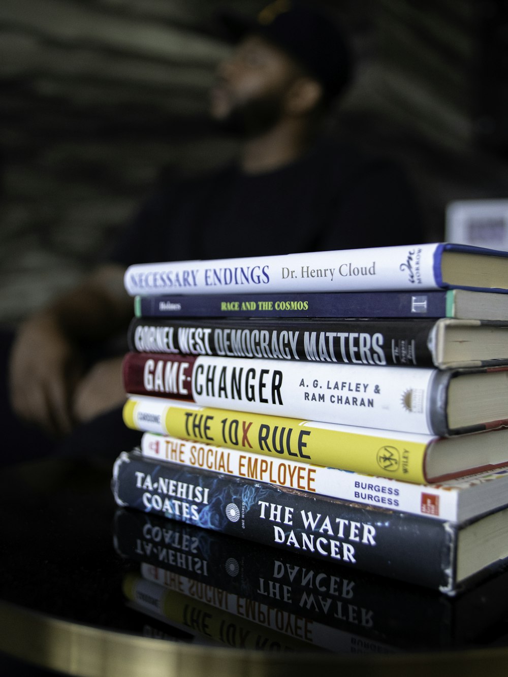 man in black shirt reading books