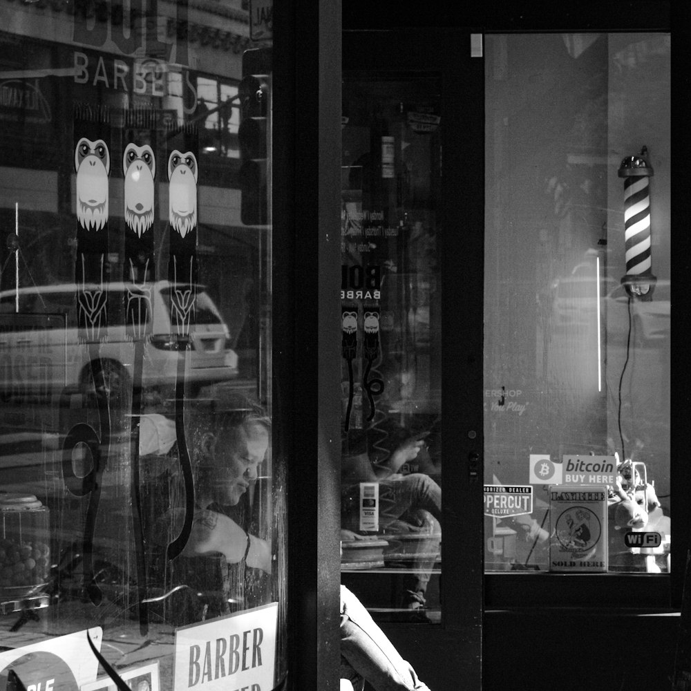 grayscale photo of man in front of mirror