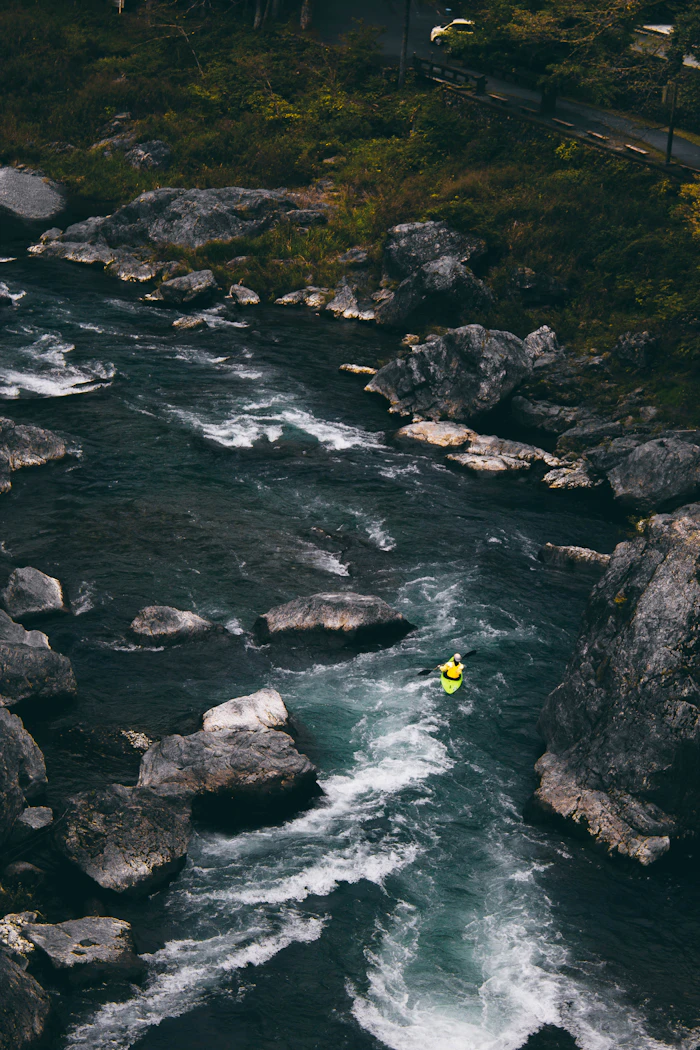 Person on a rocky riverbank