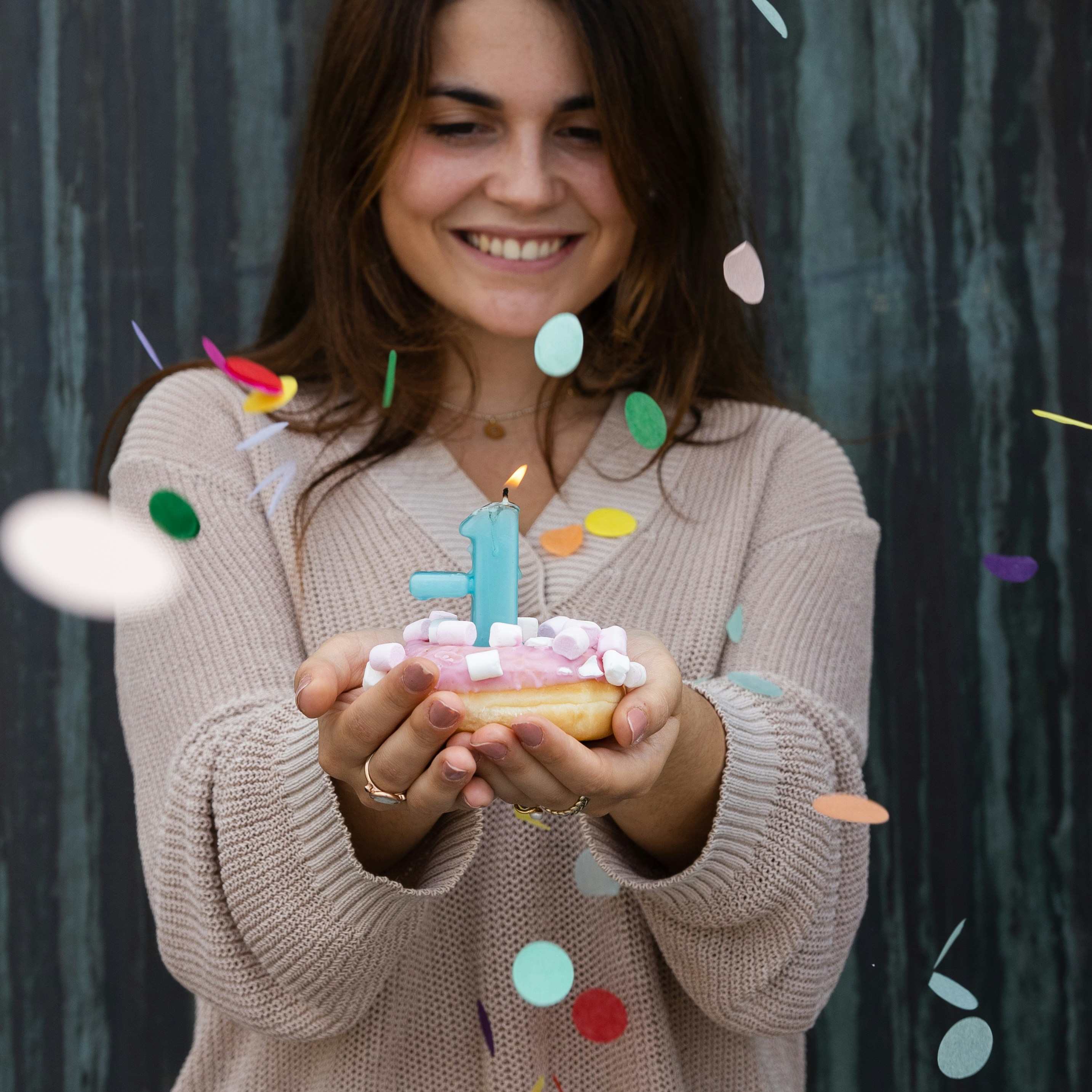 woman in gray sweater holding ice cream cone