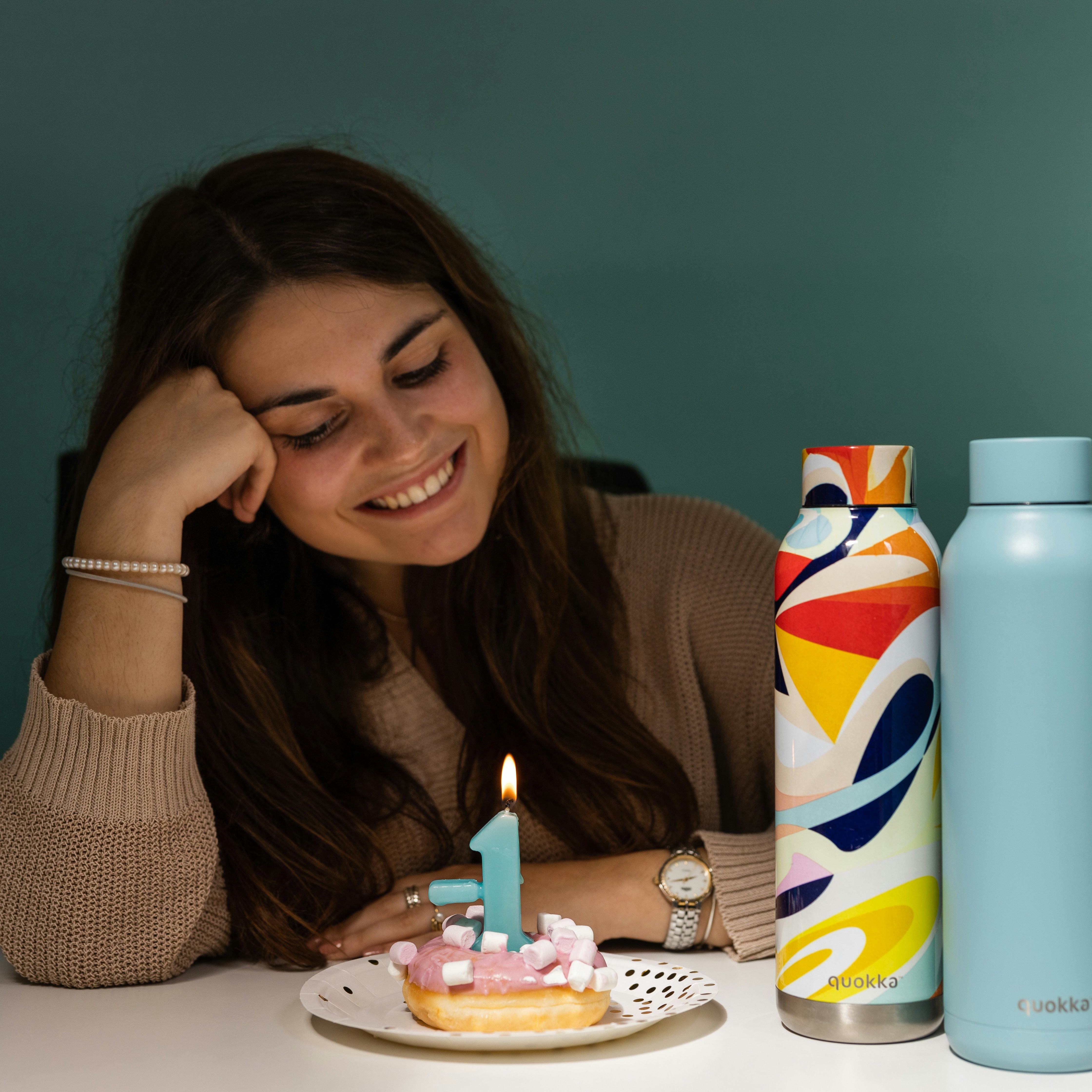 woman in black shirt holding white and blue can