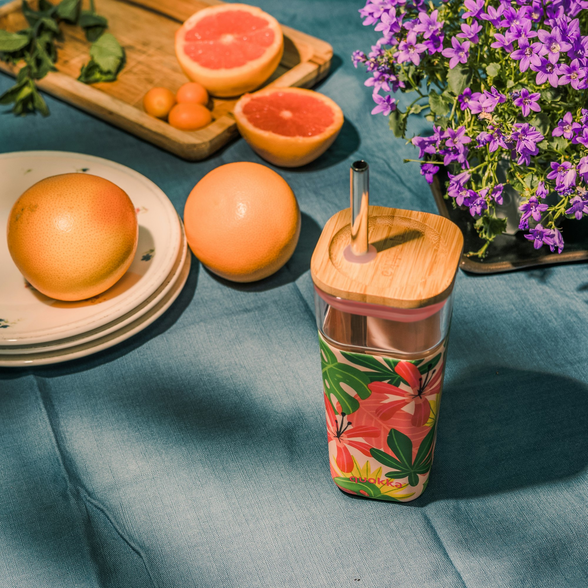 orange fruit on blue and green floral ceramic mug