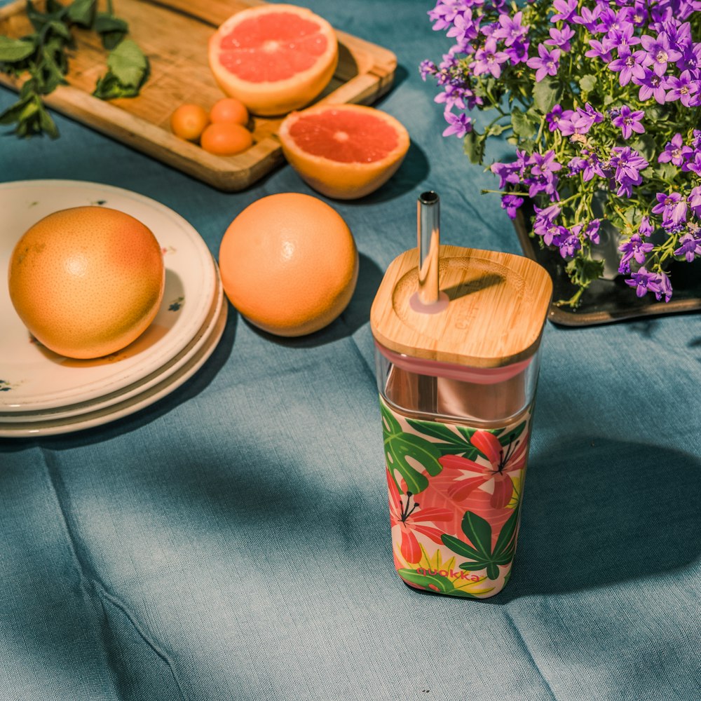 orange fruit on blue and green floral ceramic mug