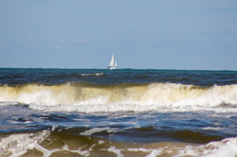 white sailboat on sea during daytime