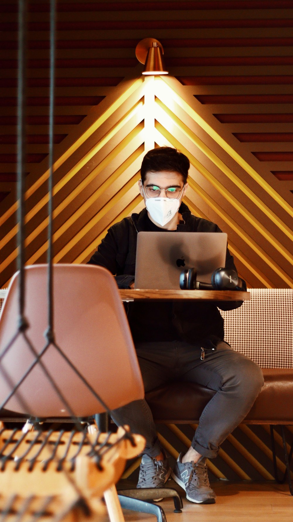 man in black suit jacket and black sunglasses sitting on brown chair