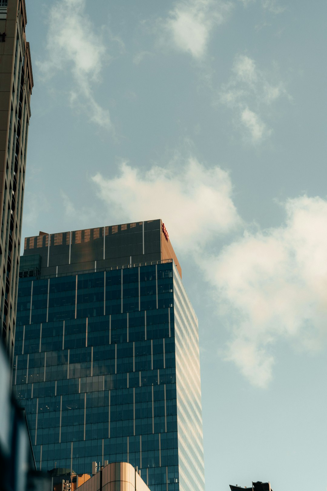 blue and brown concrete building under white clouds during daytime