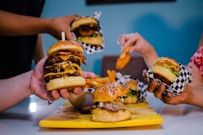 burger with patty and cheese on yellow plate