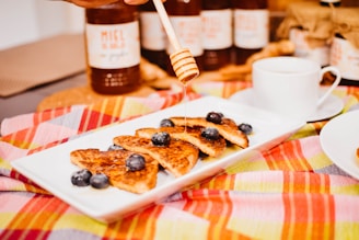 Creamed honey spread smoothly on a slice of warm, toasted bread with a drizzle of honey.
