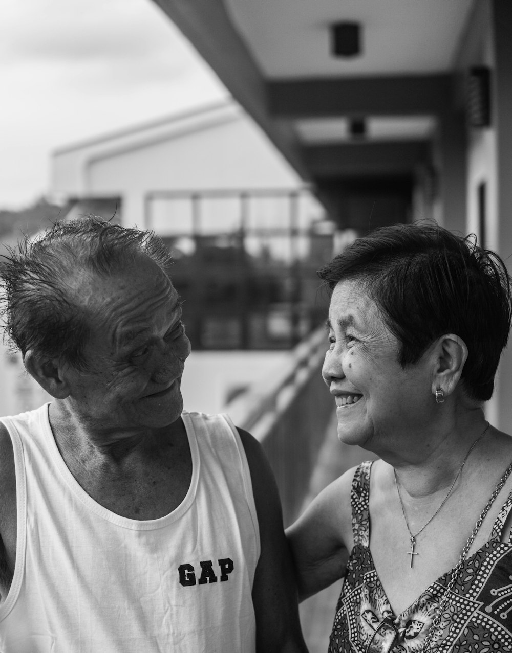 man in white tank top beside woman in black and white tank top