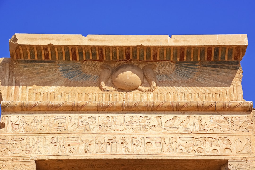 brown concrete wall with human face carved