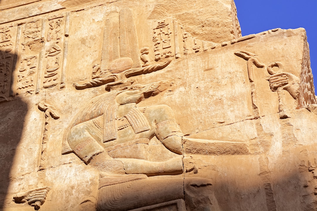 brown concrete statue under blue sky during daytime