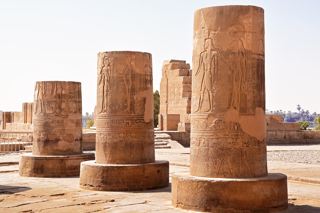 brown concrete statues on brown sand during daytime