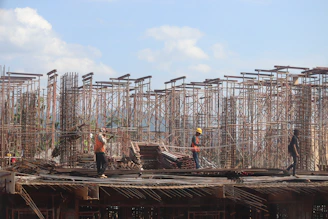 Wide shot of assembled scaffolding on a construction site with workers
