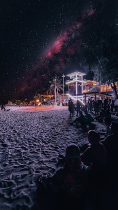 A beach scene featuring a movie screening under the stars.