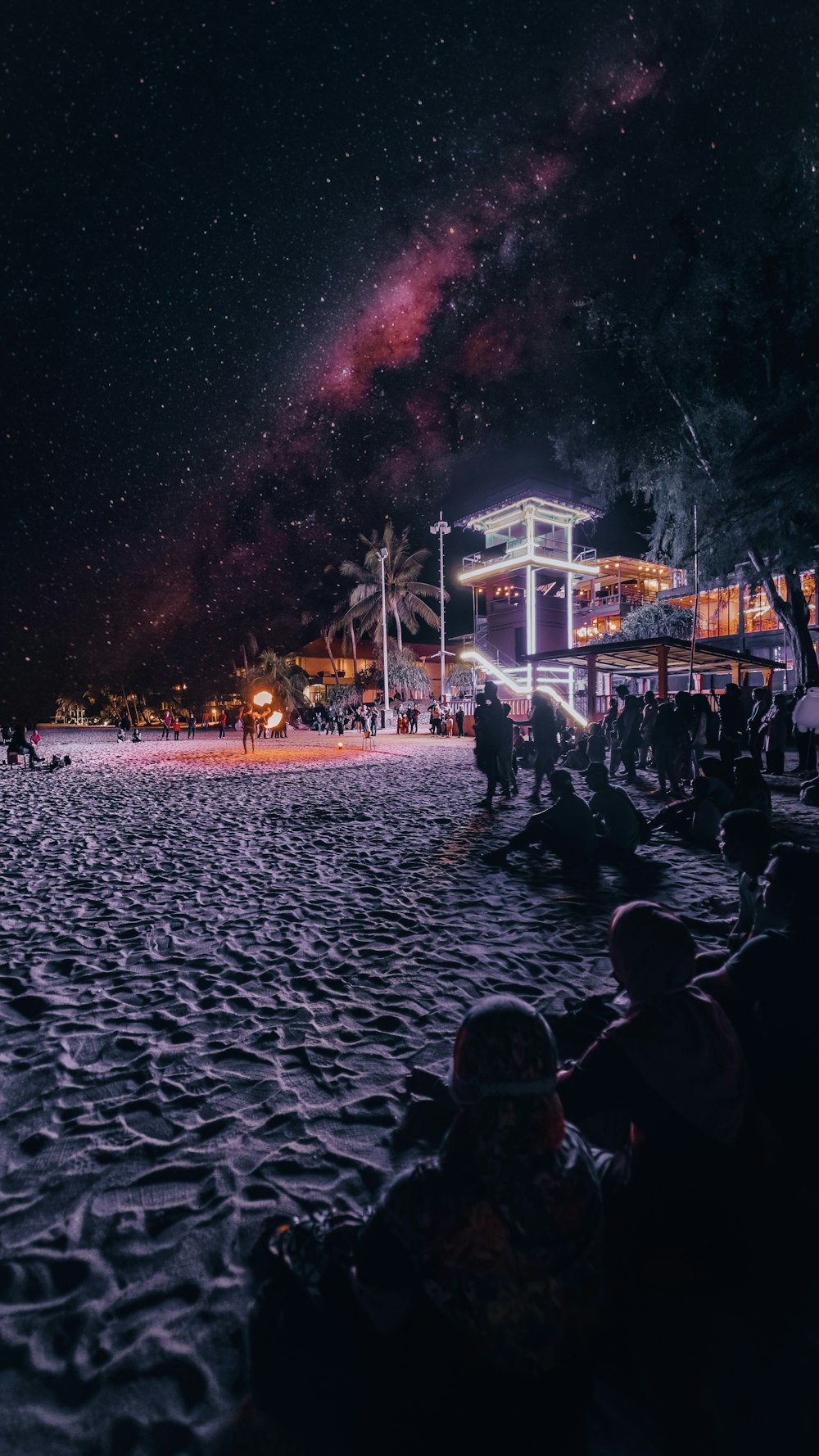 people sitting on white wooden bench during night time