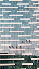 people walking on blue and white concrete building during daytime