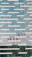 people walking on blue and white concrete building during daytime