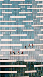 people walking on blue and white concrete building during daytime