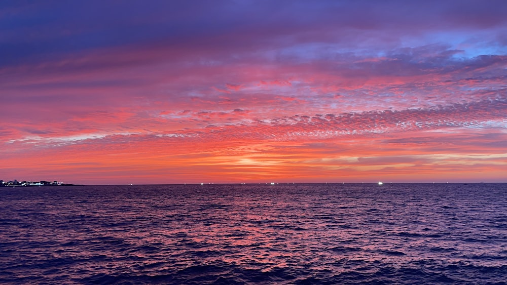 body of water during sunset