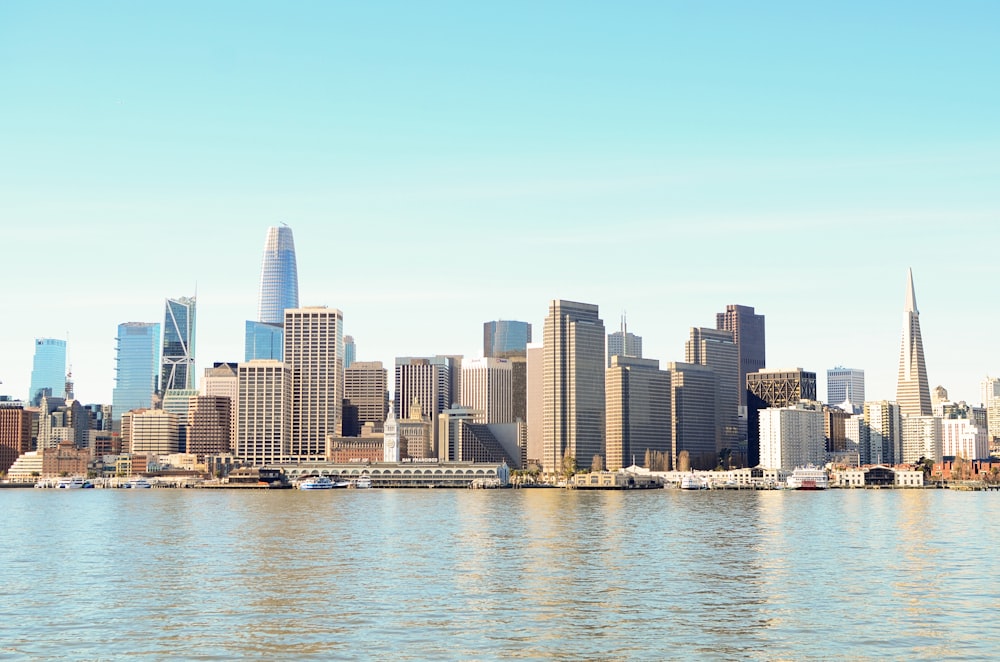 city skyline across body of water during daytime