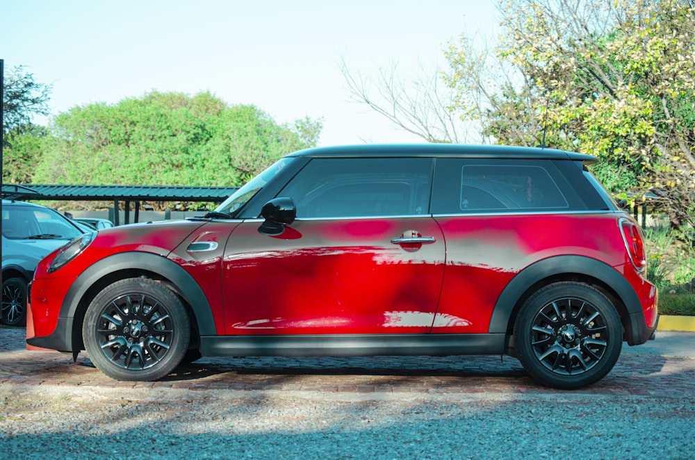 red suv parked on gray concrete road during daytime