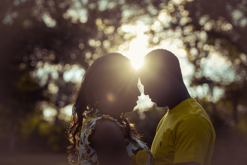 man and woman kissing during daytime