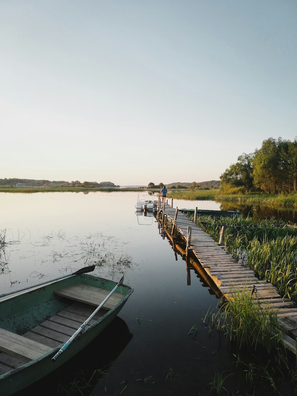 white and brown wooden boat on body of water during daytime