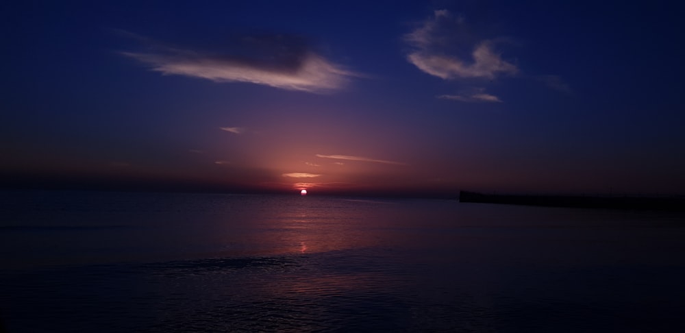 body of water during sunset