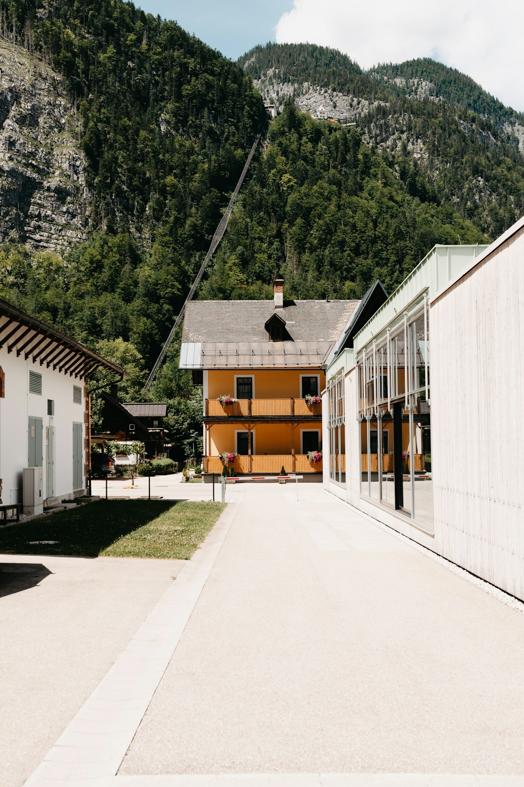 white and brown wooden house near green trees during daytime