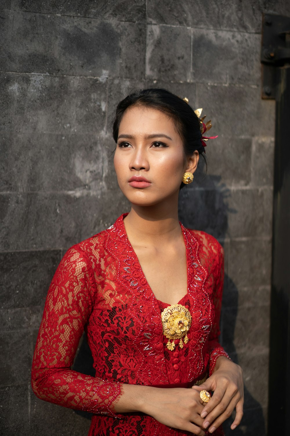 a woman in a red dress with a flower in her hair