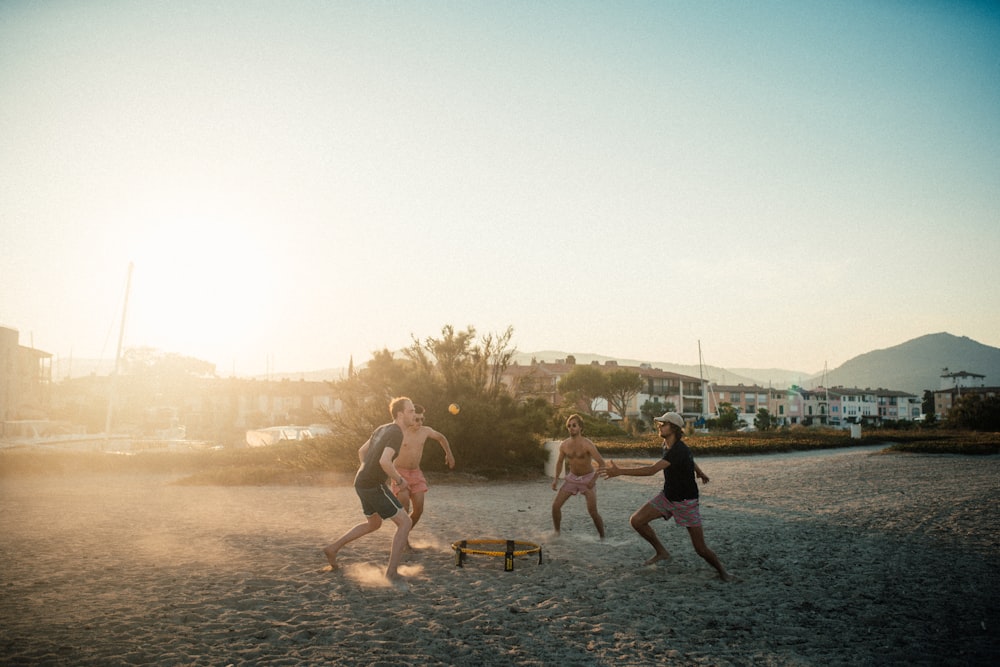 people playing on beach during daytime