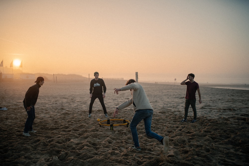 people walking on beach during sunset