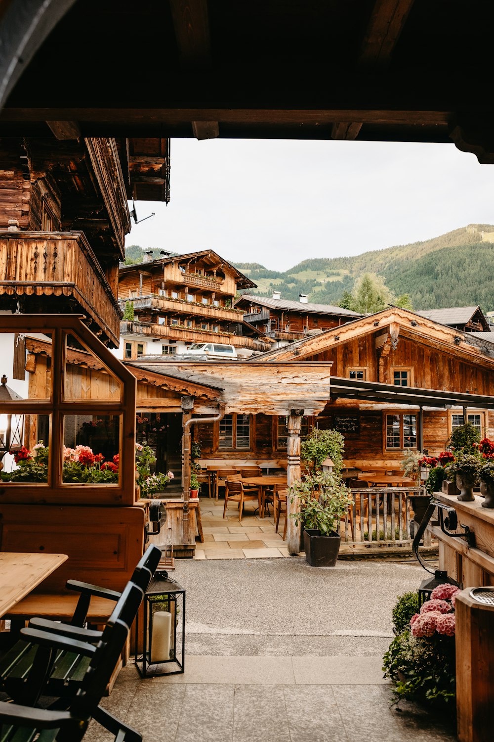 brown wooden house near green mountain during daytime