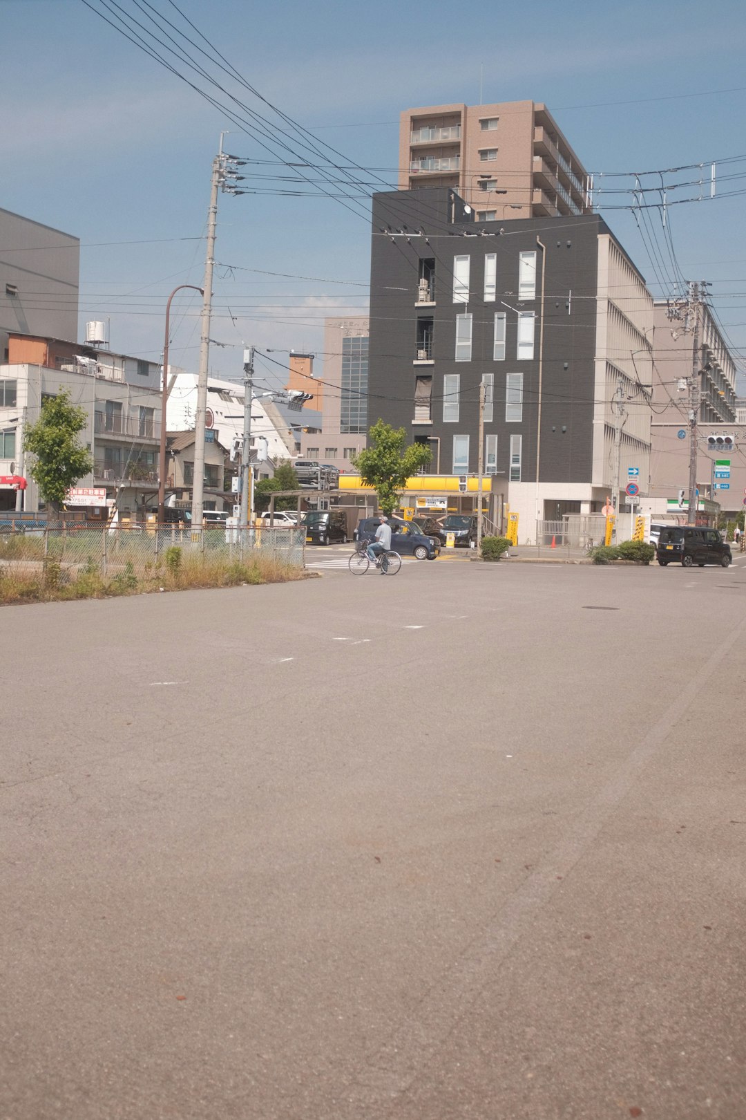 cars parked on side of the road near buildings during daytime