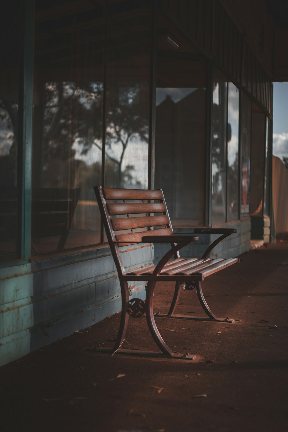 brown wooden bench near window