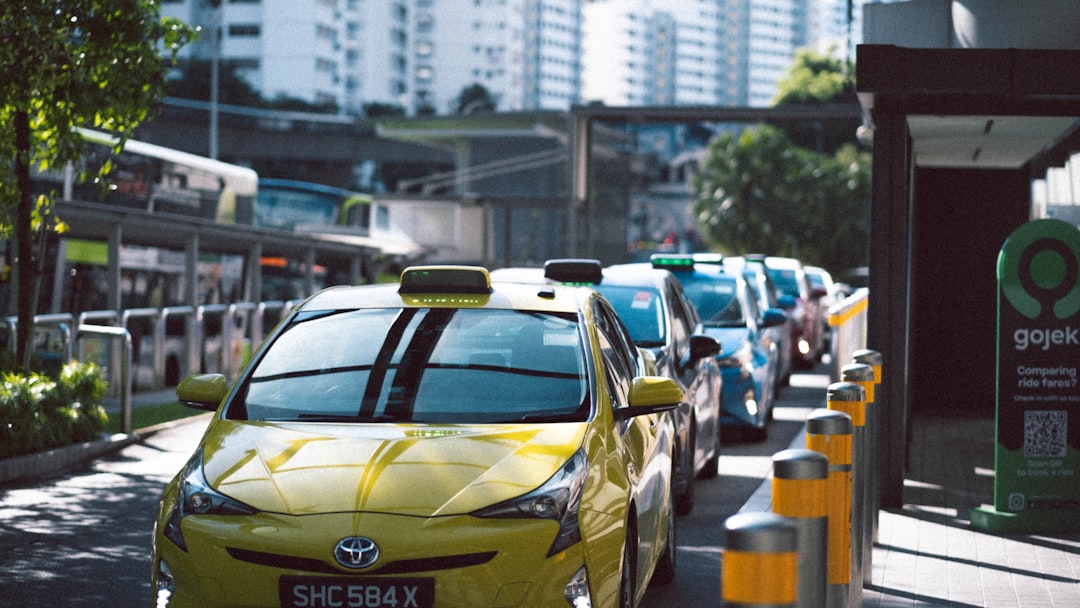 yellow and black sedan on road during daytime