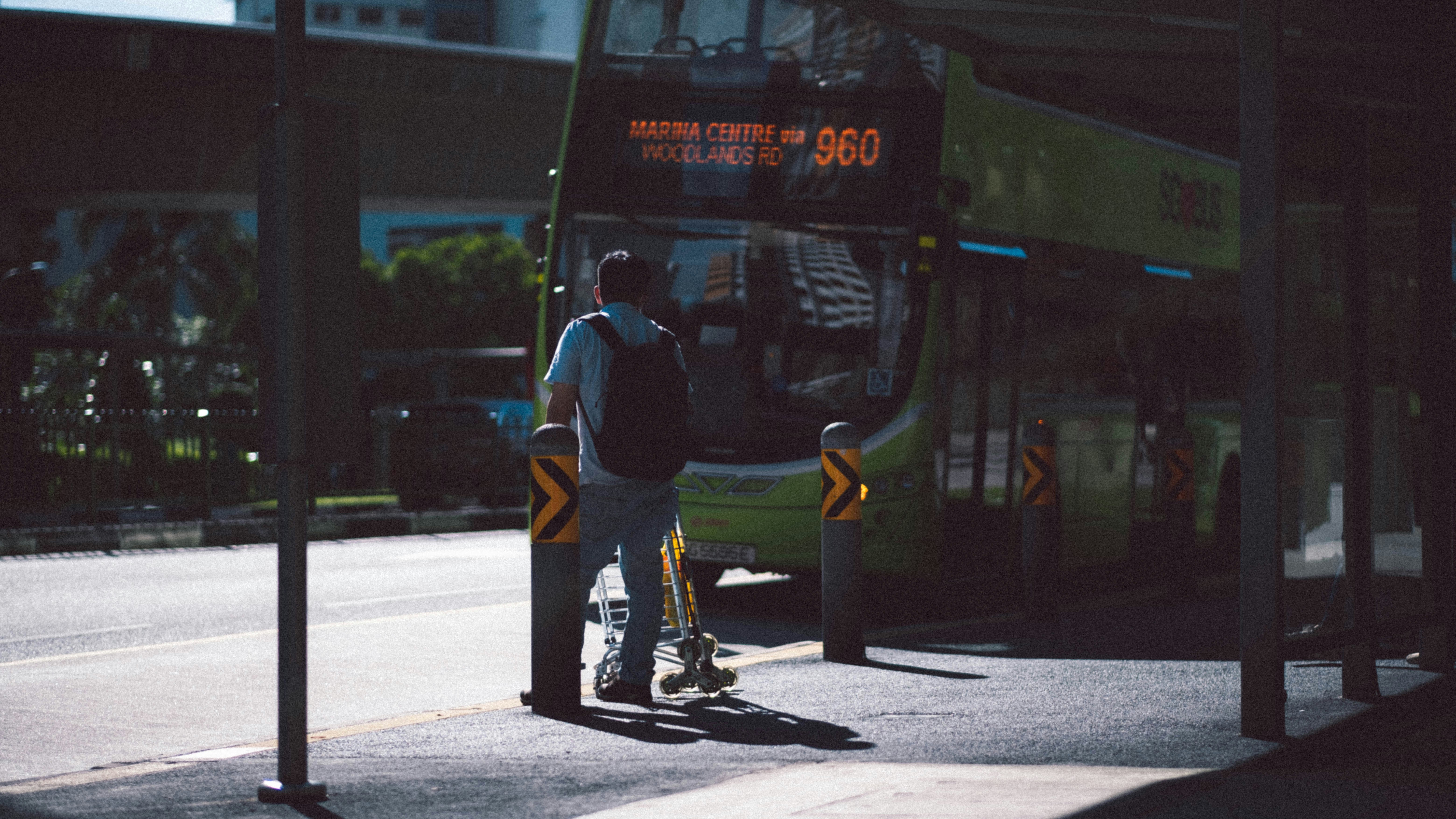 Technician performing maintenance on a bus bumper