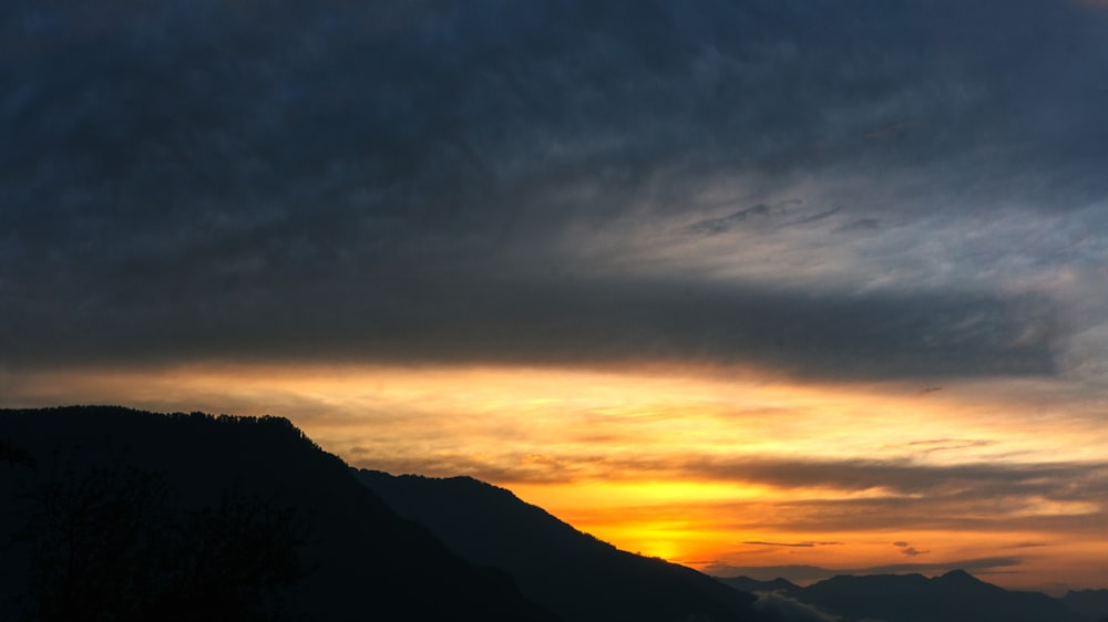 silhouette of mountain during sunset