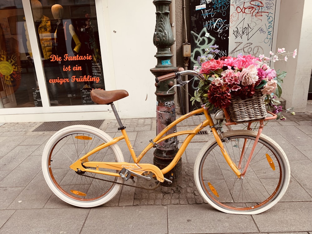 yellow city bike with flowers