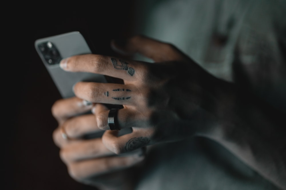 person holding silver iphone 6