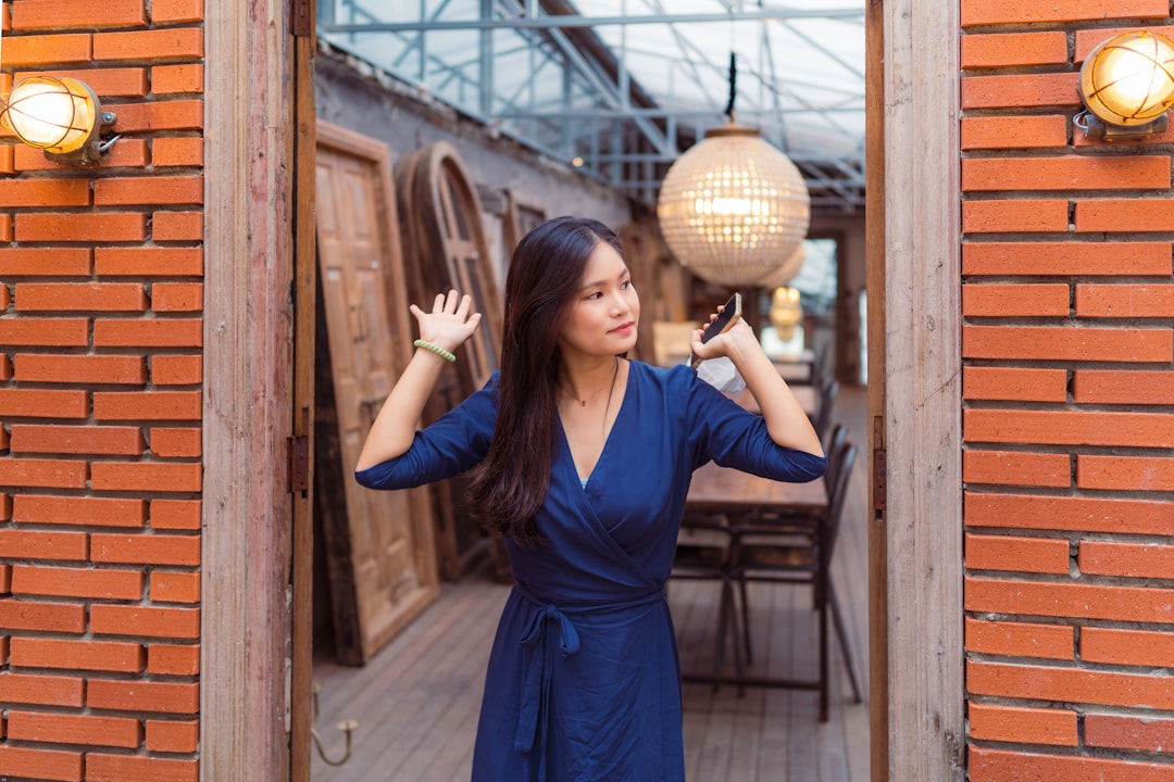 woman in blue dress holding brown wicker ball