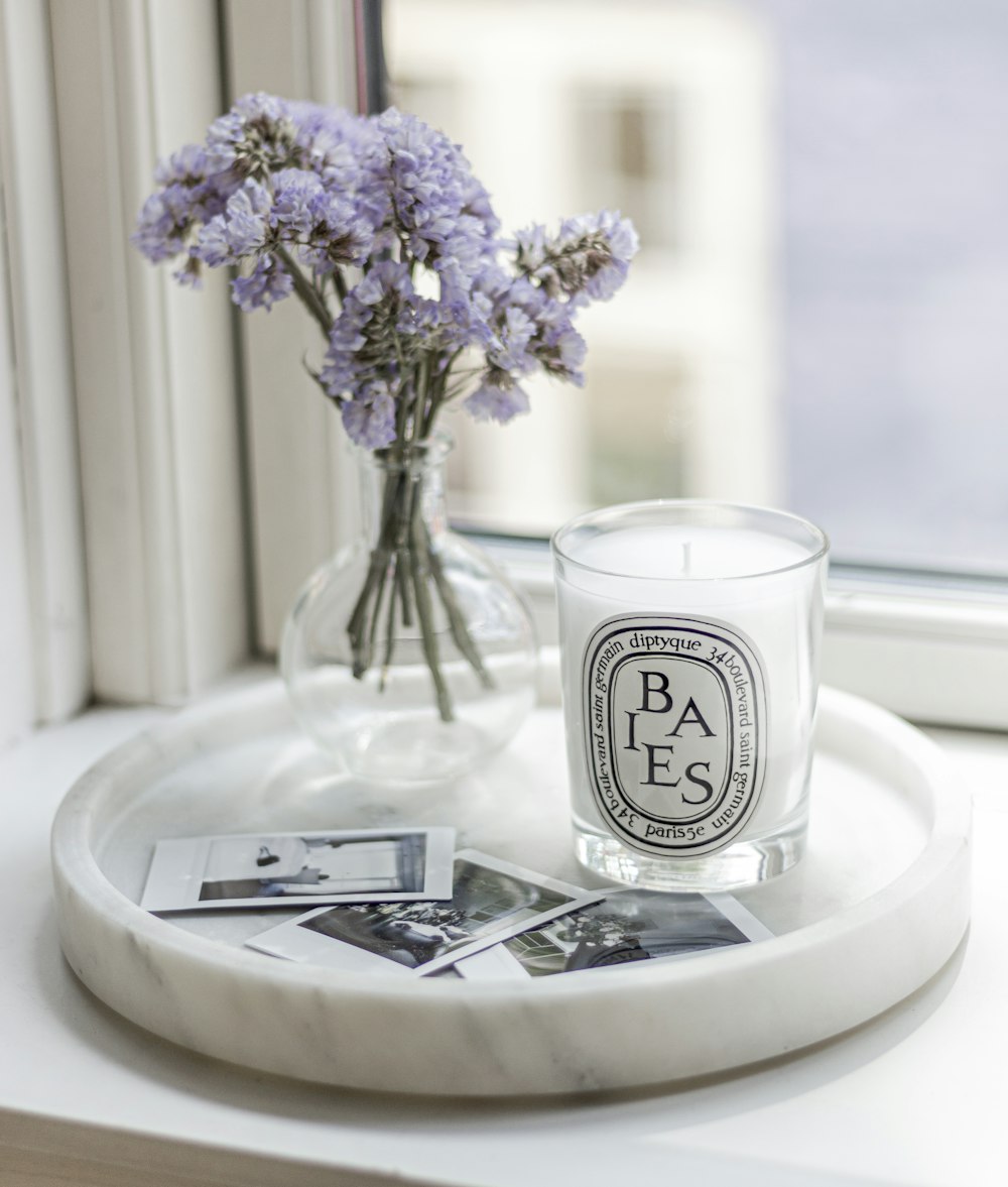 white and black ceramic mug on white ceramic plate