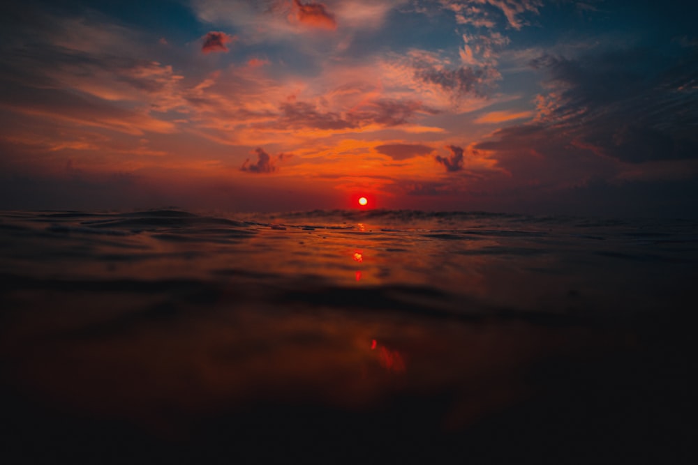 body of water during sunset