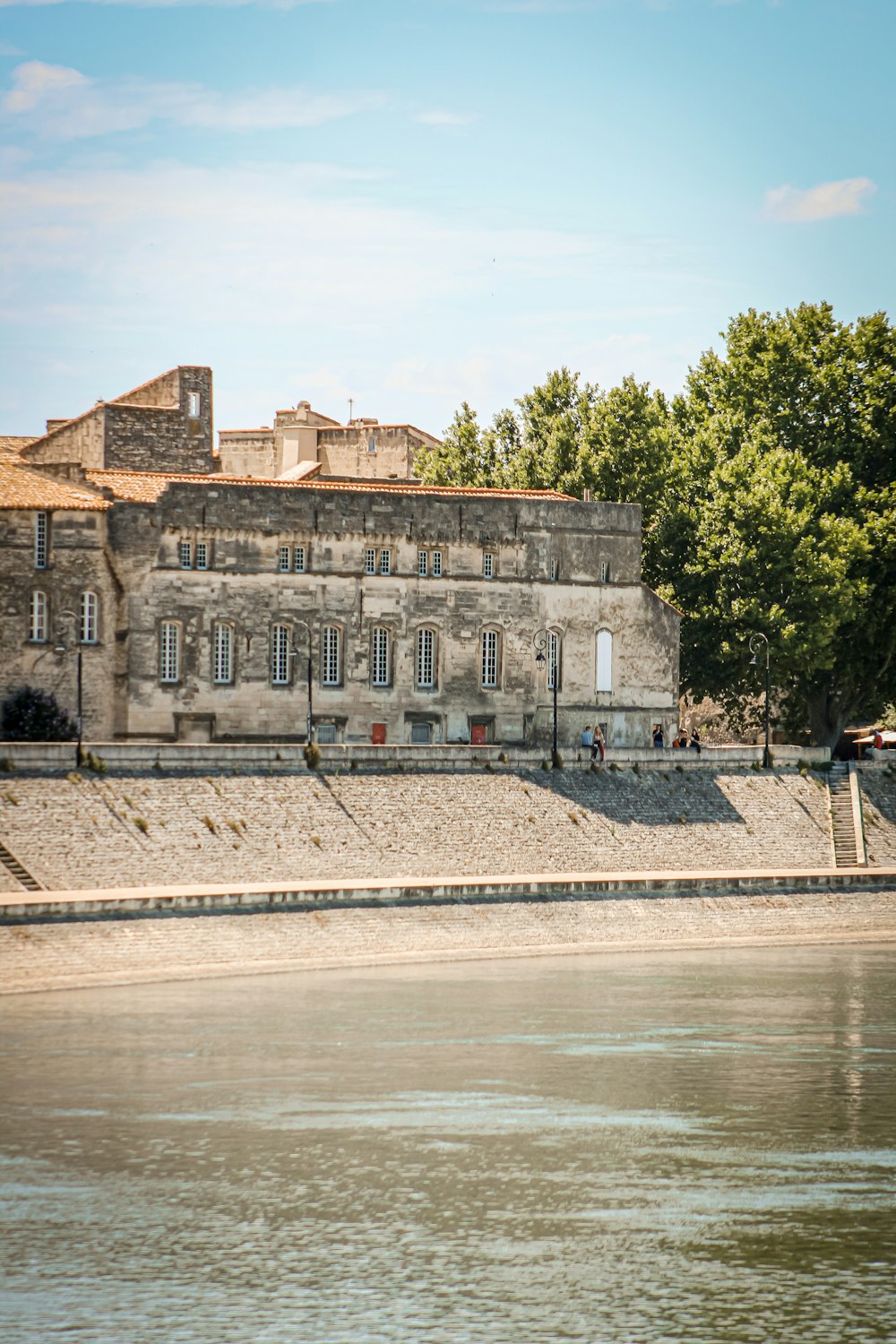 brown concrete building near body of water during daytime