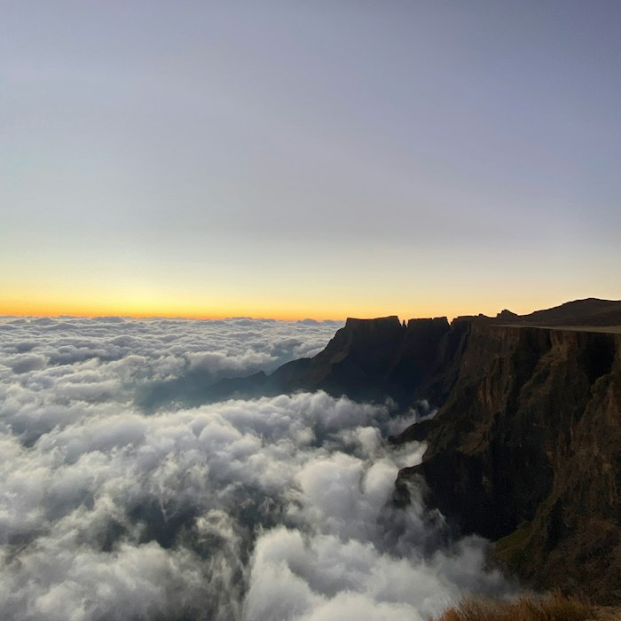 Clouds drifting over the Drakensberg mountains in Lesotho at sunrise